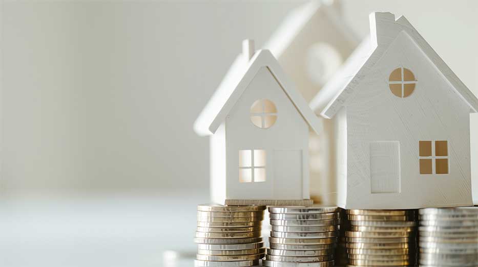 small houses sitting on coins depicting property values in spain