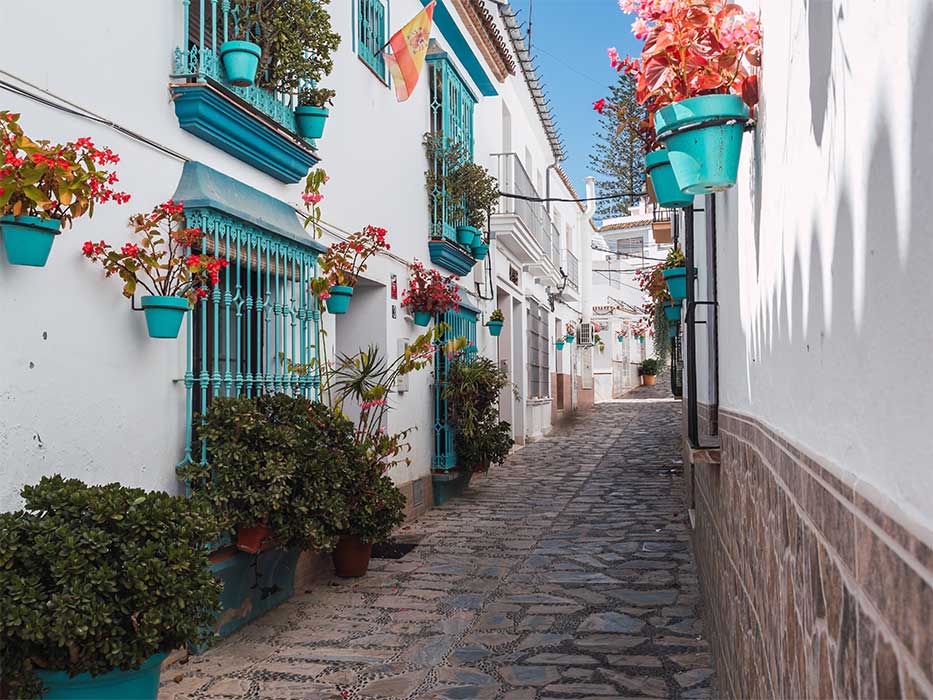 Lovely street in Estepona with flowers and plants in colourful pots. Costa del Sol, Spain