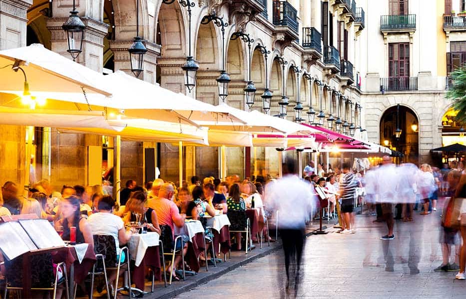 Tourists in the Royal Square (Plaça Reial) in Barcelona, Spain