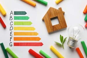 energy efficiency rating chart, house figure and light bulb on white background