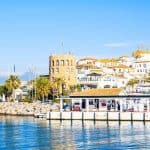 View of Puerto Banus marina with boats and white houses in Marbella town, Andalusia, Spain