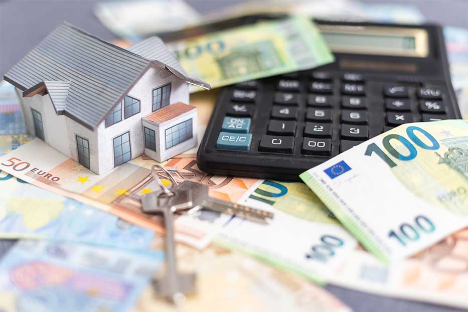 Close-up Of A House Model On Euro Bank Note Near Calculator