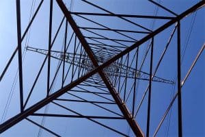 Electricity pylons conducting current from distribution power station, blackout and grid stability concept.